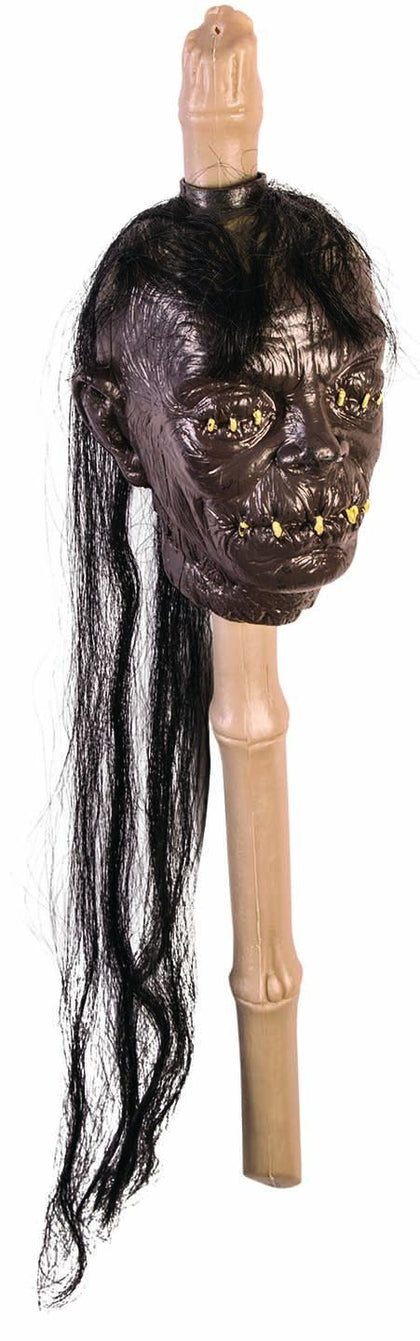 Brown head with black faux hair on tan stick