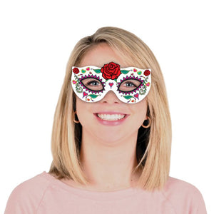 Person wearing a colorful eye mask with floral designs on a white background