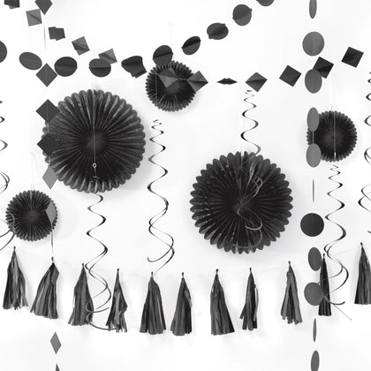 Black party decorations including paper fans, tassels, and streamers on a white background