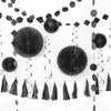 Black party decorations including paper fans, tassels, and streamers on a white background