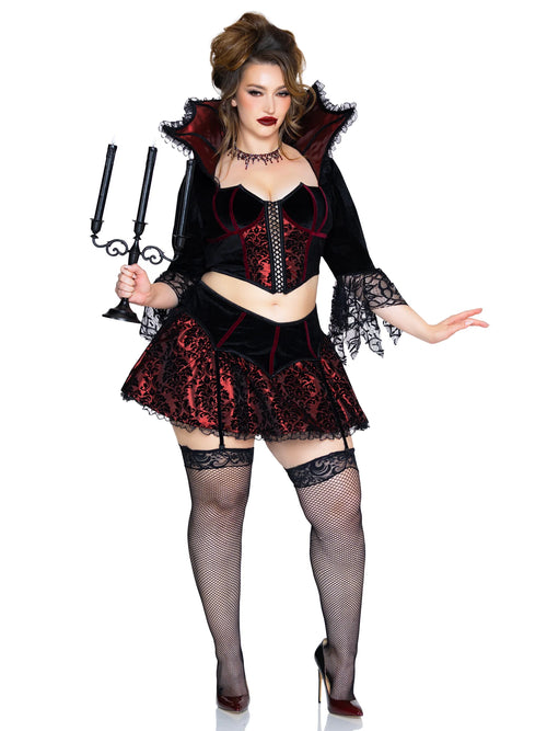 A woman modeling a gothic vampire costume against a plain white background. The costume features a black and red lace corset top with a high collar, a matching red and black lace mini skirt, black lace-trimmed thigh-high stockings, and a black collar with red trim.