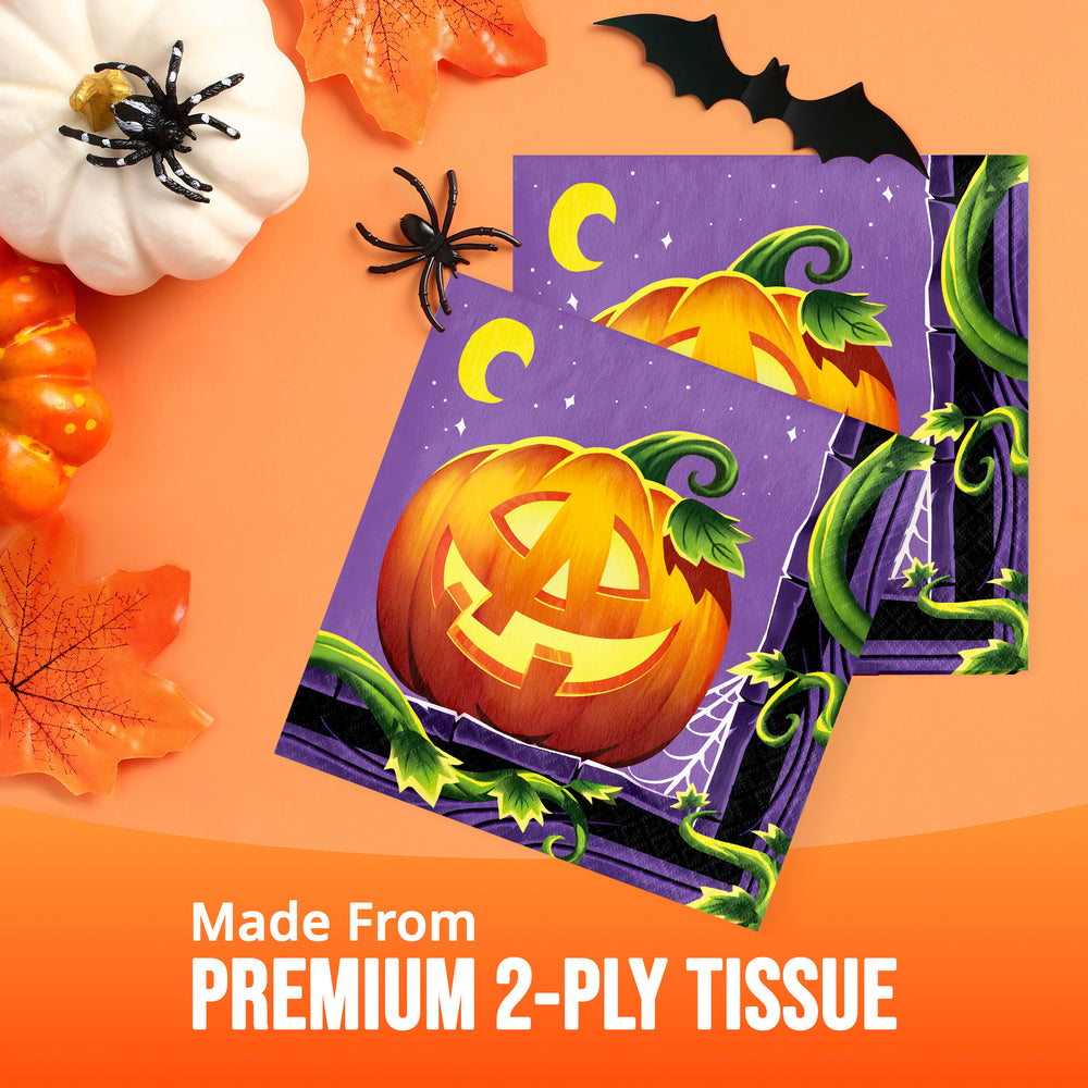 Two Halloween-themed tissue papers with a purple background, a carved orange pumpkin, green vines, and crescent moons, displayed on an orange background with autumn props and the text 'Made From PREMIUM 2-PLY TISSUE'.