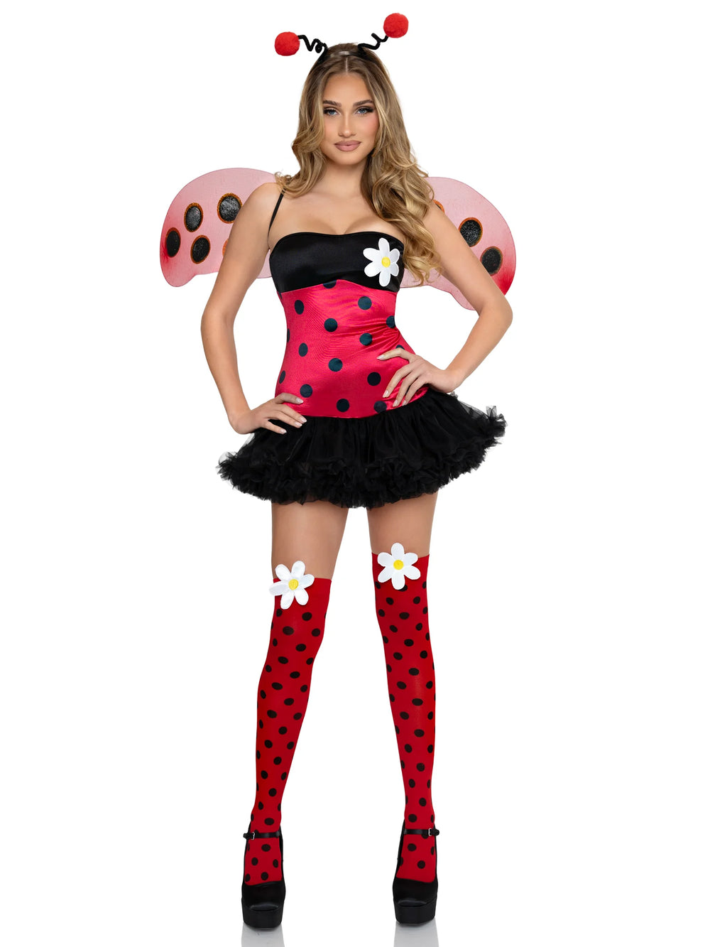 A woman modeling a ladybug costume consisting of a red and black polka-dot strapless top with a black tutu skirt, pink wings with black spots, red polka-dot thigh-high socks, and white flower accessories, on a plain white background.