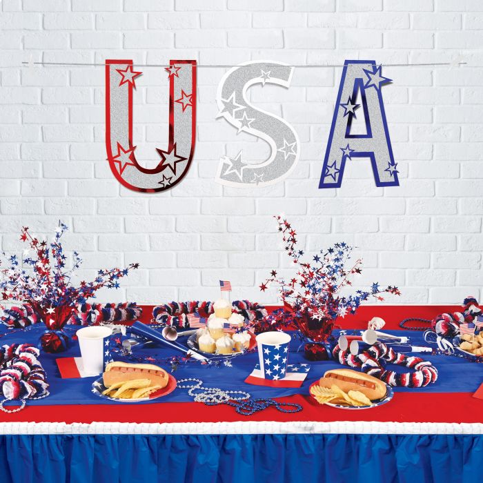 Table setting with 'USA' decoration on a white brick wall background