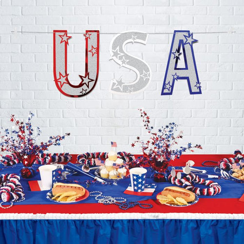 Table setting with 'USA' decoration on a white brick wall background
