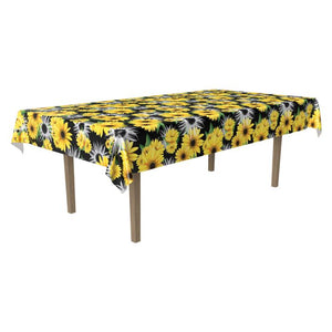 Table with a yellow sunflower patterned tablecloth on a white background