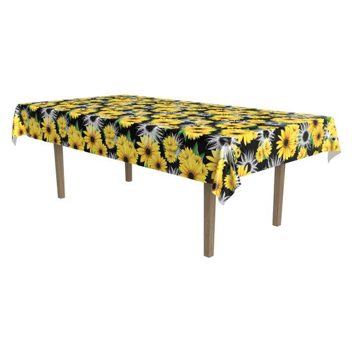Table with a floral tablecloth featuring yellow flowers on a white background