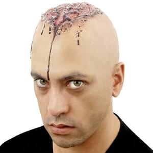 Person with a bald head and decorative patterns on the scalp against a white background
