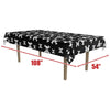 Black tablecloth with white skull and crossbones pattern, displayed on a table with measurements indicated.
