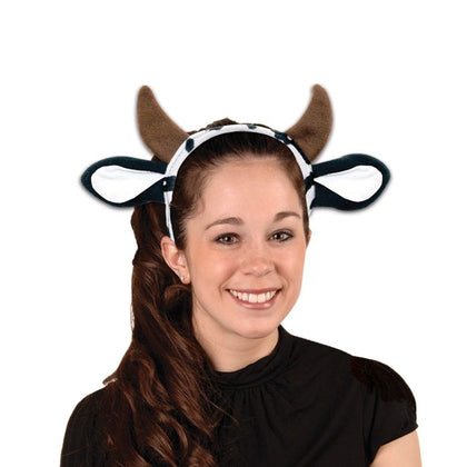 Person wearing a headband with cow ears on a white background