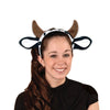 Person wearing a headband with cow ears on a white background