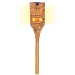 Bamboo tiki torch with face design on a white background