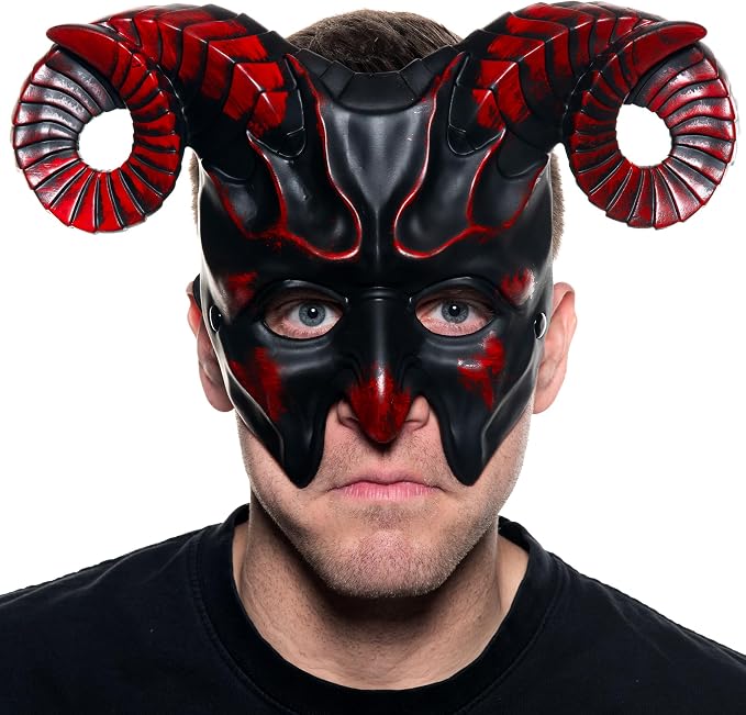 A man wearing a black and red horned mask, photographed against a plain white background.
