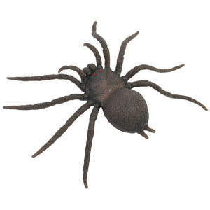 A realistic black spider toy or decoration with eight long legs and small red eyes, isolated on a white background.
