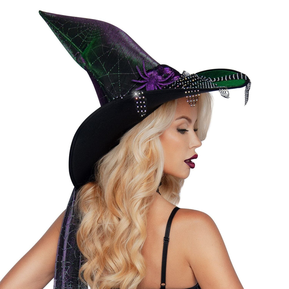 Woman in a witch costume with a black hat and gloves on a white background