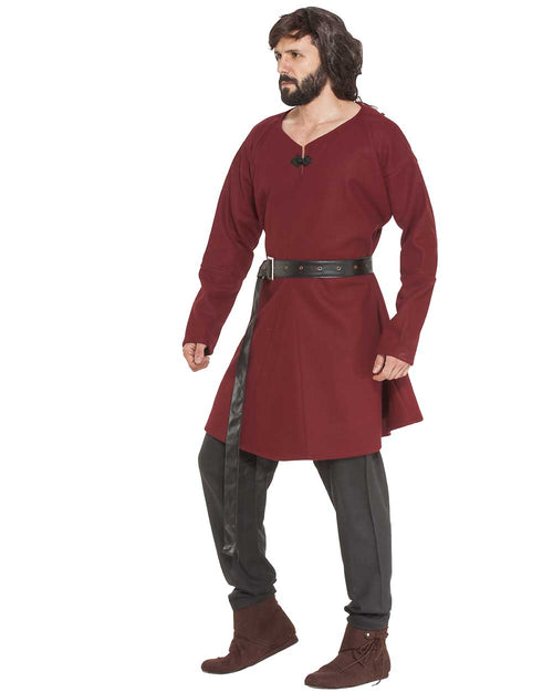 Man wearing a red tunic with a belt and dark pants on a white background