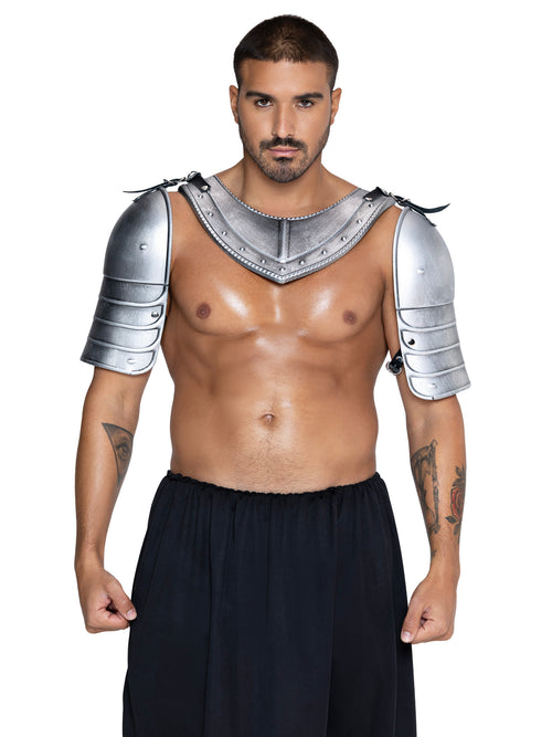 A man modeling a silver metallic gladiator-style shoulder and chest armor piece with black pants, photographed against a plain white background.