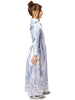 Child wearing a white dress with blue patterns on a white background