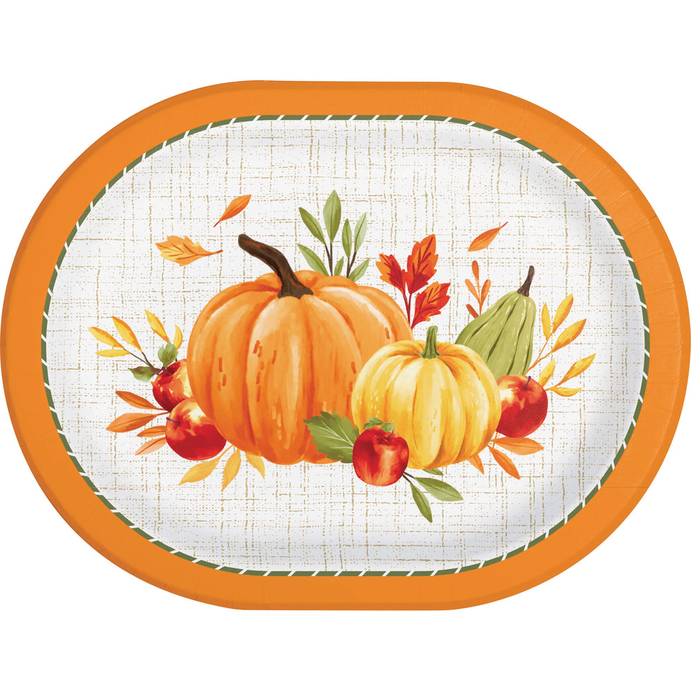An oval decorative serving platter with a bright orange rim and a fall harvest illustration featuring two pumpkins, apples, leaves, and a pear on a white textured background.