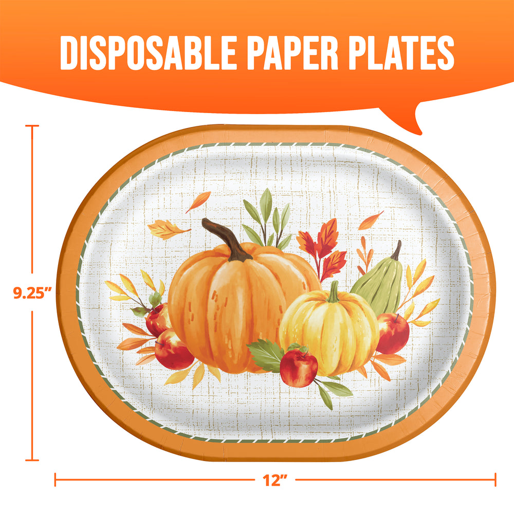 An oval disposable paper plate with a fall harvest design featuring pumpkins, apples, and autumn leaves on a white textured background with a tan rim. The image includes orange dimension lines and text indicating 12 inches by 9.