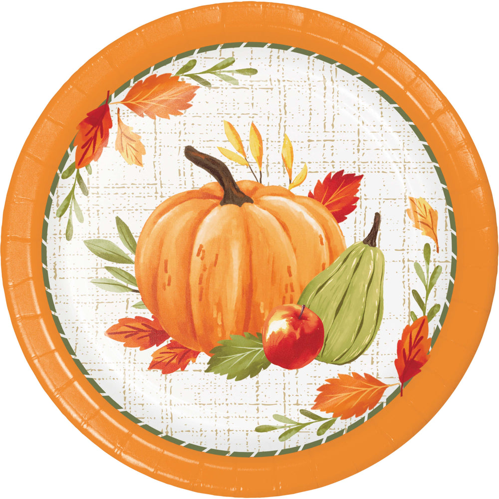 A round paper plate with a fall harvest design, featuring an orange pumpkin, green pear, red apple, and autumn leaves on a white patterned background with a bright orange rim.