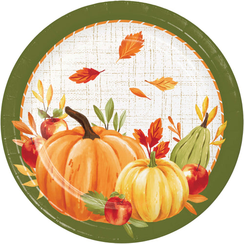 A round autumn-themed paper plate or placemat featuring pumpkins, apples, leaves, and a green border on a white background.