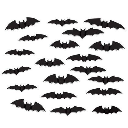 Set of black bat-shaped decorations on a white background