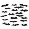 Set of black bat-shaped decorations on a white background