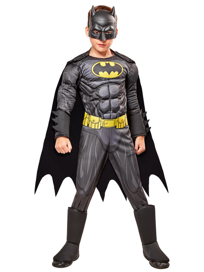 Child wearing a Batman costume with a black cape and yellow bat symbol on a white background