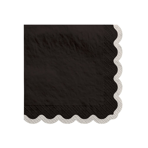 Black paper napkin with scalloped edge on a white background