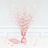 Decorative rose gold confetti showering from a rose gold vase on a white background