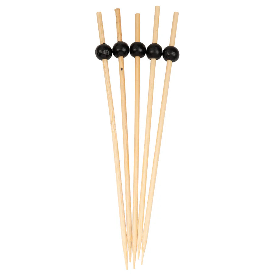 Set of wooden skewers with black beads on a white background