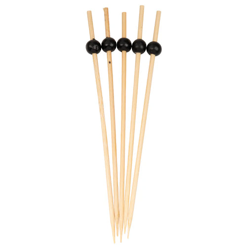Set of wooden skewers with black beads on a white background