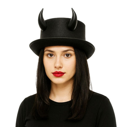 A woman wearing a black top hat with two curved horns, photographed against a plain white background.
