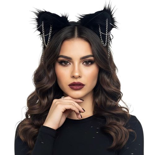 A woman with long wavy brown hair wearing a black cat-ear headband with silver chain details, posed against a solid white background.