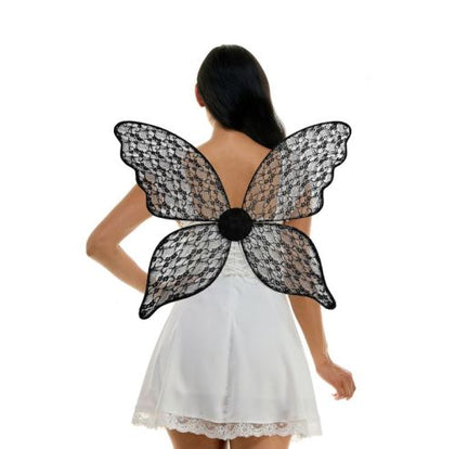 Person wearing black lace butterfly wings on a white background