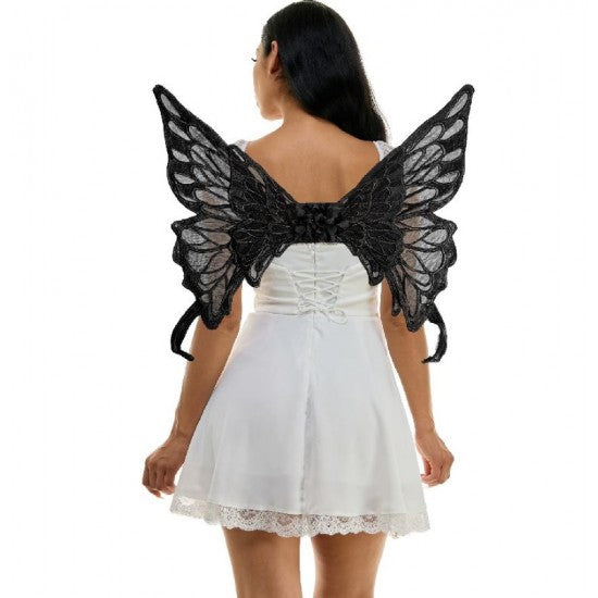 Person wearing black butterfly wings on a white background