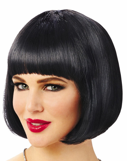 A woman wearing a short, straight black bob wig with blunt bangs, shown against a plain white background.