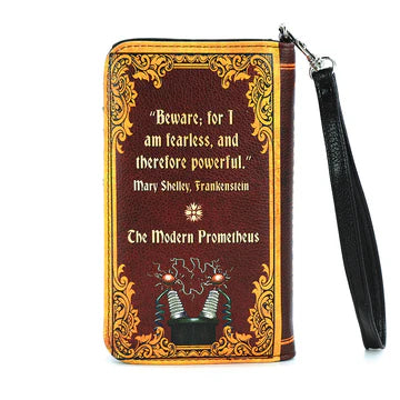 Book-shaped wallet with decorative cover and black wrist strap on a white background