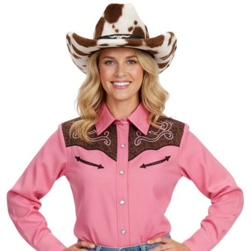 Woman wearing a pink western-style shirt with brown accents and a cow print hat on a white background