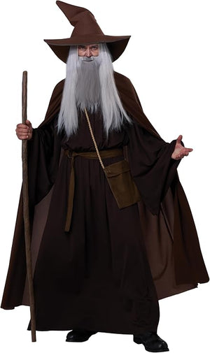 A person wearing a wizard costume with a dark brown pointed hat, long white beard, dark brown robe, brown belt pouch, and holding a wooden staff against a plain white background.