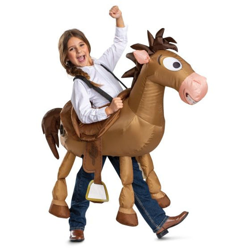 A child wearing a brown inflatable toy horse costume, riding a brown inflatable horse with a saddle and stirrup, against a white background.