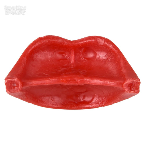 Red rubber mold shaped like lips on a white background