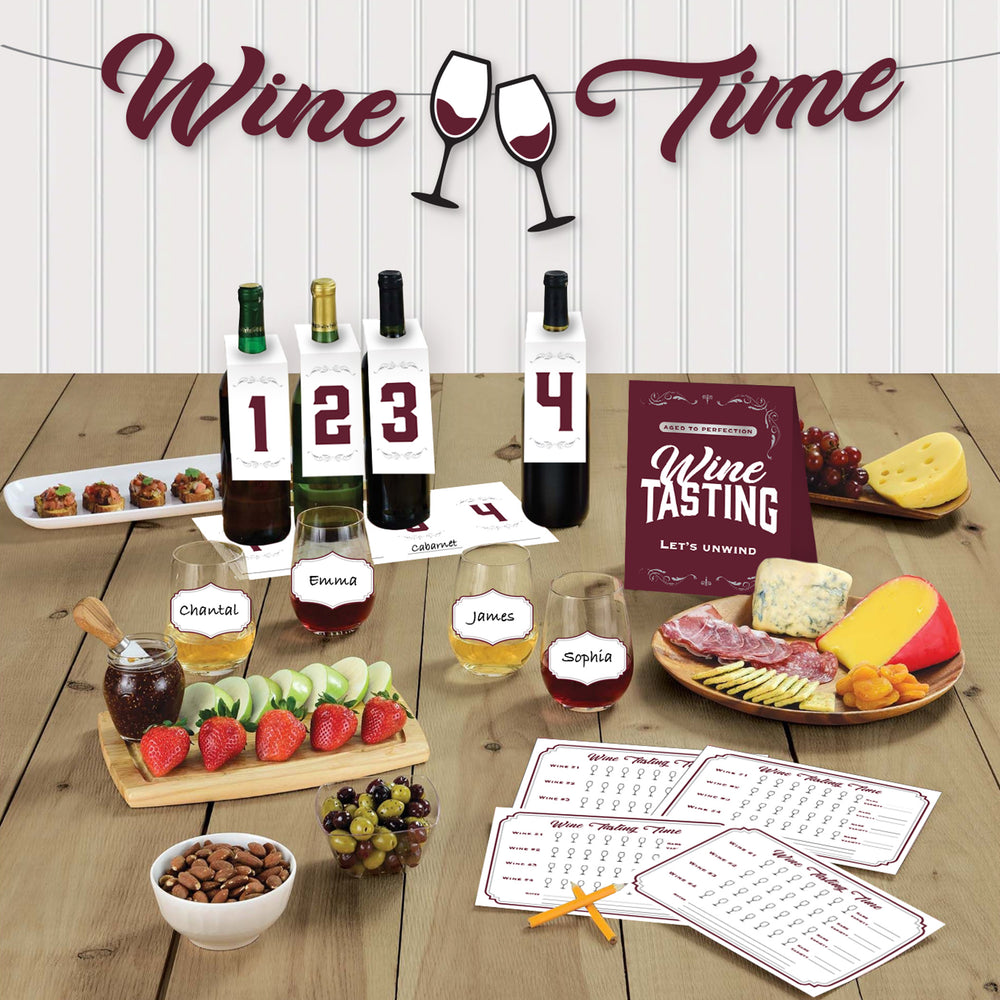 Wine tasting setup with wine bottles, glasses, and food on a wooden table.