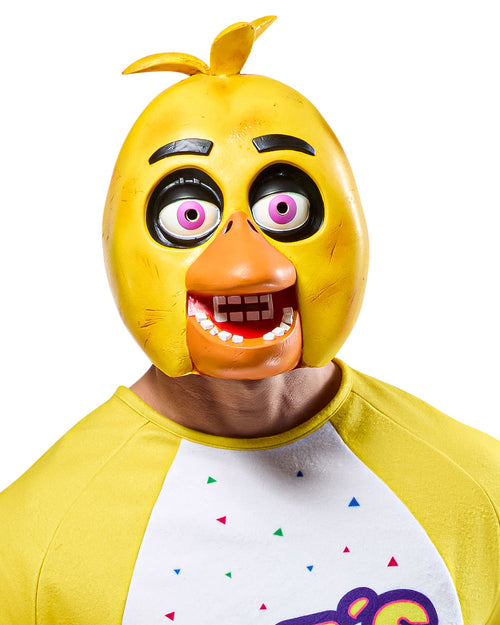 Person wearing a yellow chicken mask with a white shirt featuring colorful designs.