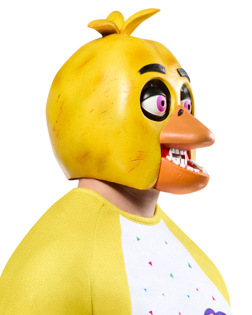 Person wearing a yellow chicken mask with a white shirt featuring colorful designs.