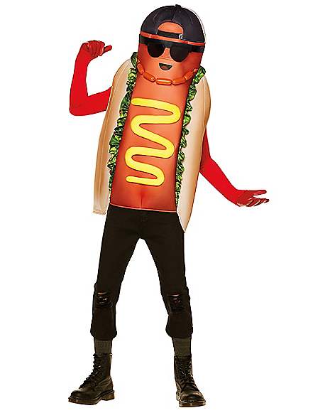 A person modeling a hot dog costume with a printed hot dog body, beige bun, red sleeves, green lettuce, yellow mustard, black pants, black boots, and a black cap with sunglasses against a plain white background.