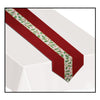 Red table runner with holly design on a white tablecloth