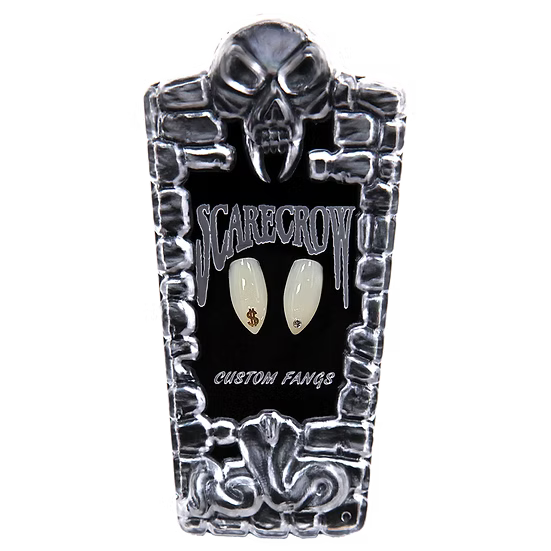 A coffin-shaped display card for custom nail art fangs, featuring a skull at the top, a black center with the words 'SCARECROW' and 'CUSTOM FANGS', and two sample fangs mounted in the middle. The fangs are off-white with small gold and black details.