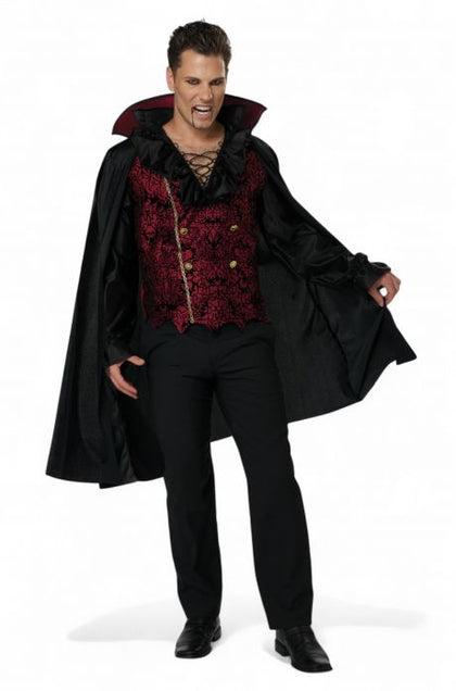 Man wearing a vampire costume with a black cape and red accents on a white background